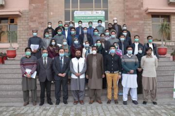 01.Group photo of  participants alongwith DG Health, VC and Registrar KMU at the end of three days  workshop on  Biosafty (Custom)1612852568.JPG